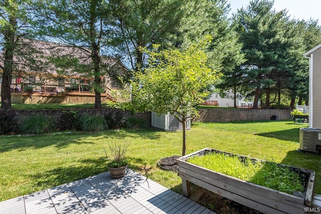 view of yard featuring a storage shed and central air condition unit