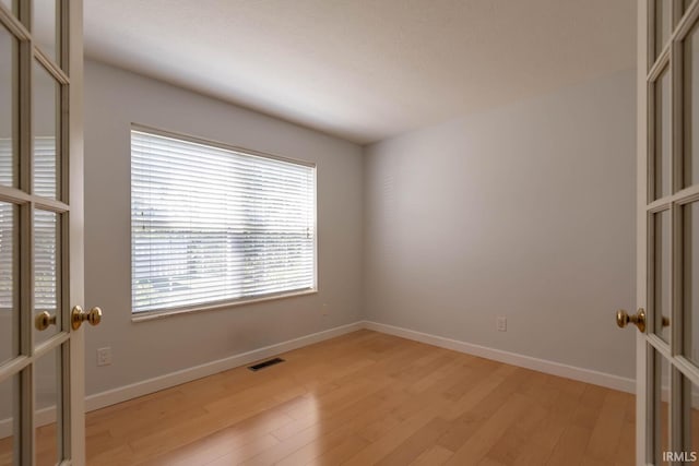 spare room featuring light hardwood / wood-style floors