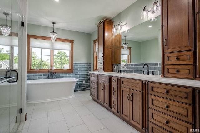 bathroom with vanity, tile patterned floors, tile walls, and a healthy amount of sunlight