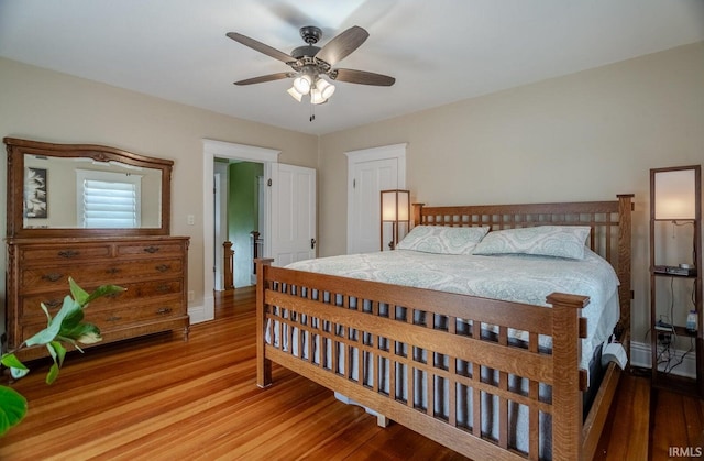 bedroom with wood-type flooring and ceiling fan