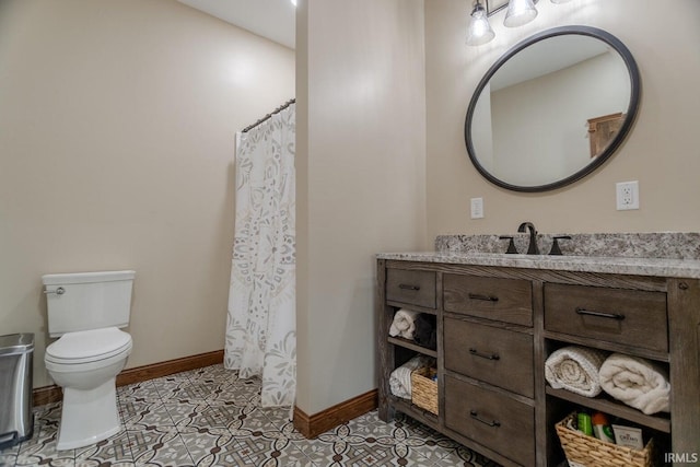 bathroom with tile patterned floors, vanity, toilet, and curtained shower