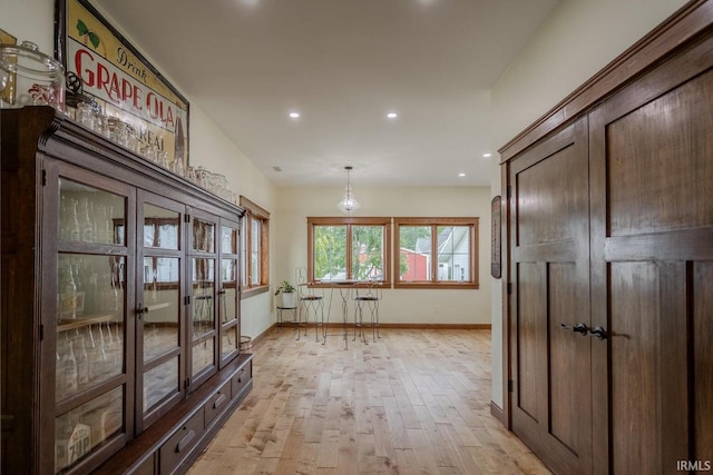 corridor with light hardwood / wood-style flooring