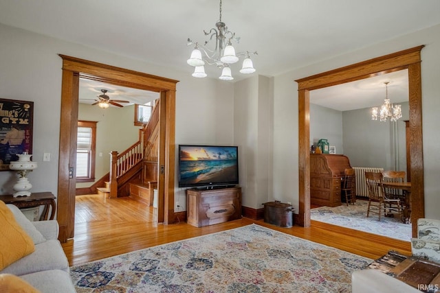 living room with hardwood / wood-style flooring and a notable chandelier