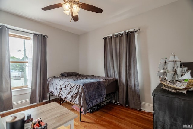 bedroom with ceiling fan and wood-type flooring