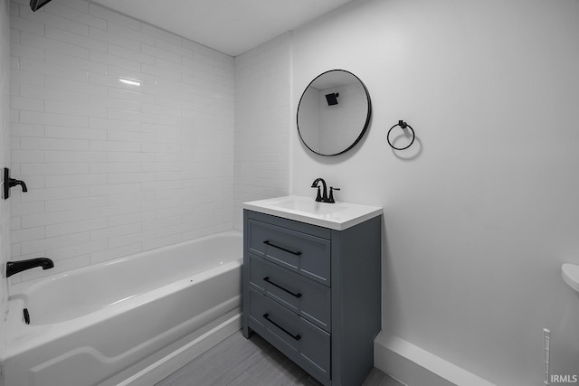 bathroom with vanity and tiled shower / bath combo