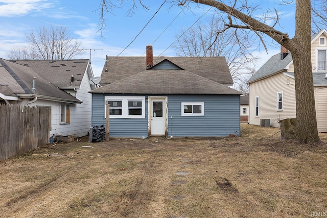 back of house featuring a yard and central AC