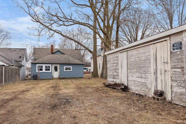 rear view of property with an outbuilding