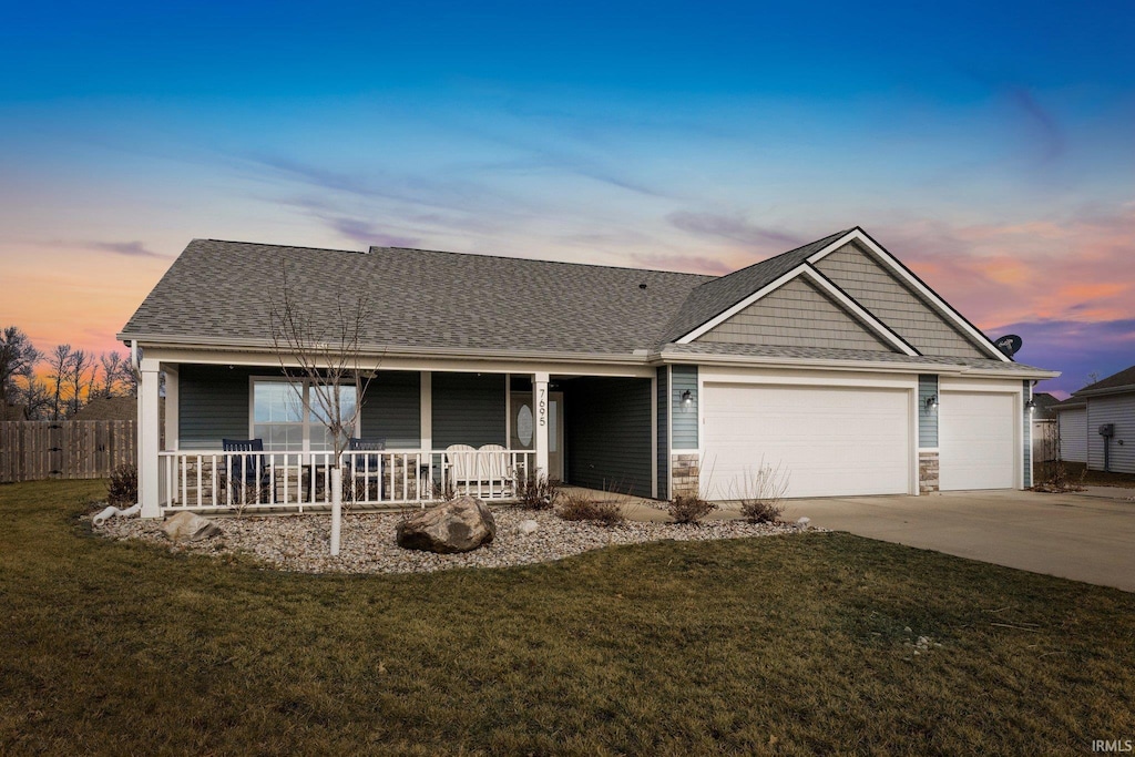 7695 Accio Cv, Fort Wayne, IN 46835 - view of front of house with a yard, a garage, and a porch