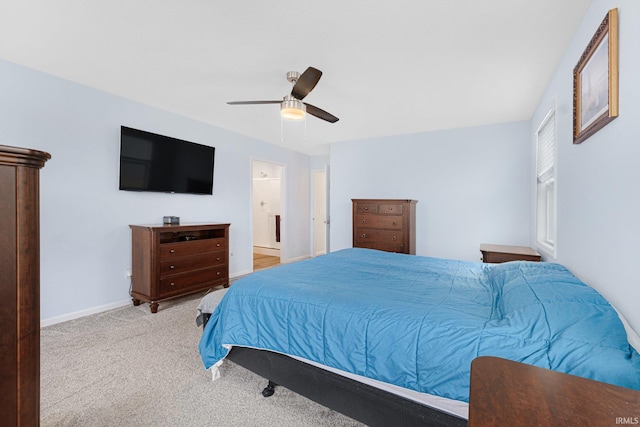 carpeted bedroom featuring ceiling fan and ensuite bathroom