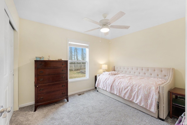 bedroom with ceiling fan, a closet, and light carpet