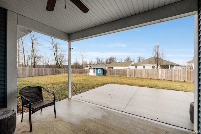 view of patio / terrace with ceiling fan and a storage shed