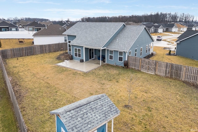 back of property with a lawn and a patio