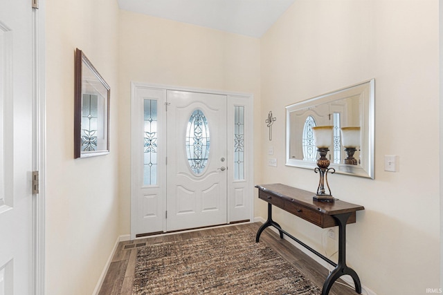 foyer featuring vaulted ceiling and hardwood / wood-style floors