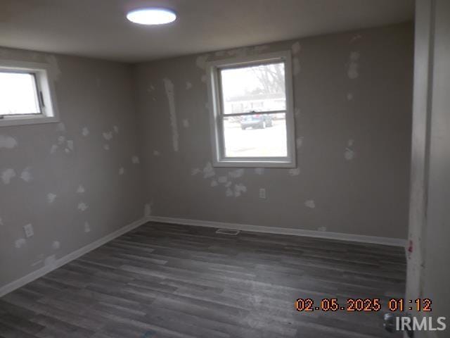 spare room with dark wood-type flooring