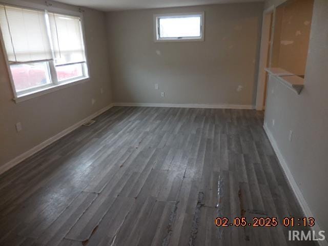 empty room featuring dark hardwood / wood-style flooring