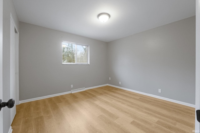 unfurnished room with light hardwood / wood-style floors