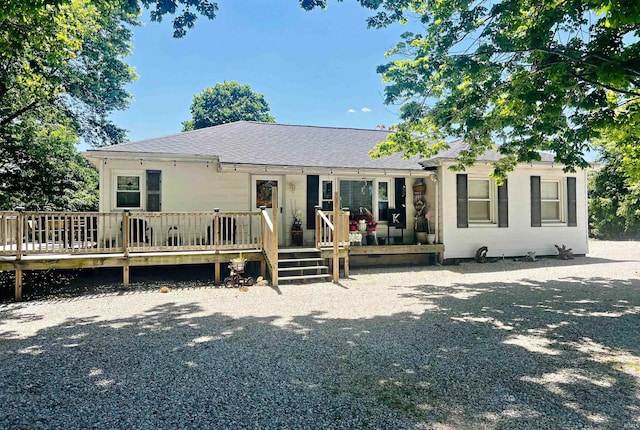 rear view of property featuring a deck