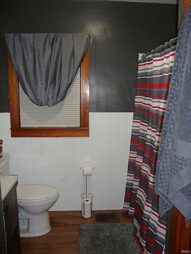 bathroom featuring wood-type flooring, vanity, and toilet