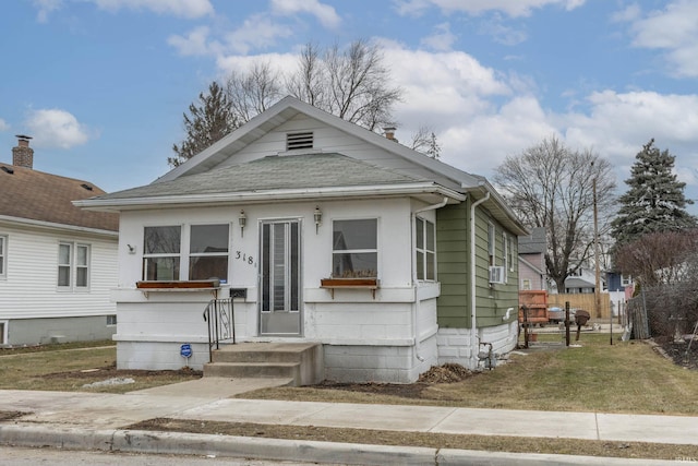 bungalow-style house with a front yard