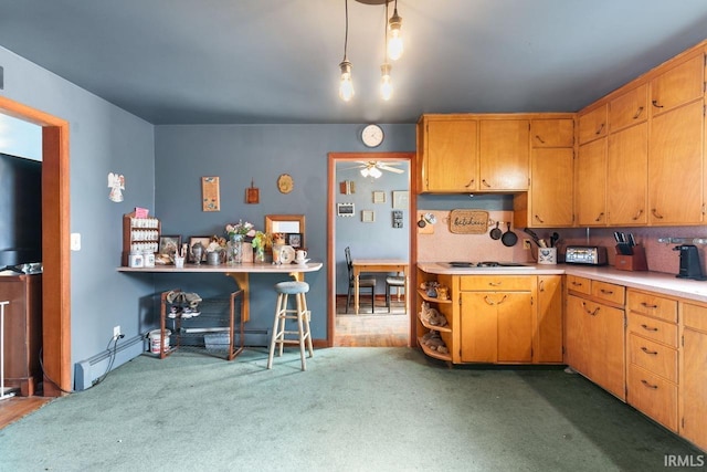 kitchen with pendant lighting, ceiling fan, and carpet