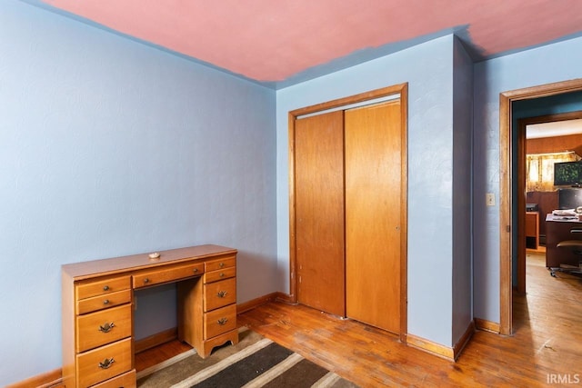 office with light wood-type flooring