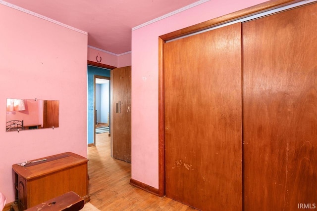 corridor featuring crown molding and light wood-type flooring