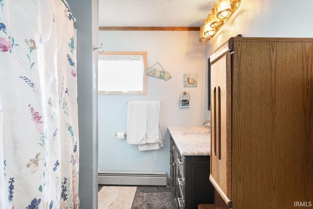 bathroom with ornamental molding, a baseboard heating unit, curtained shower, and vanity