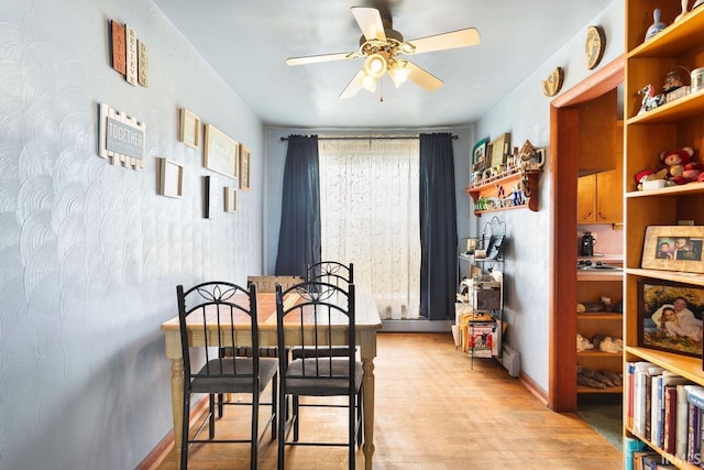 dining area with ceiling fan and light hardwood / wood-style flooring