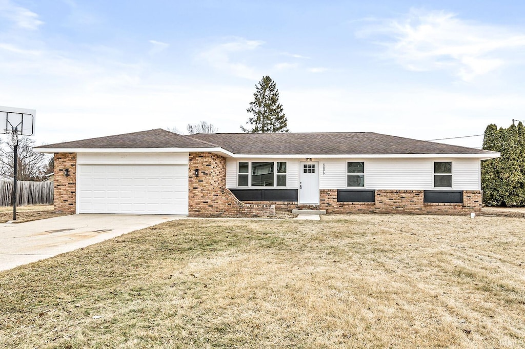 single story home with a garage and a front yard