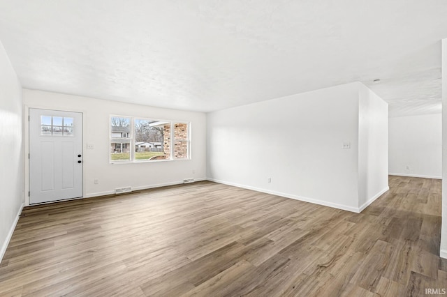 unfurnished living room with light hardwood / wood-style floors