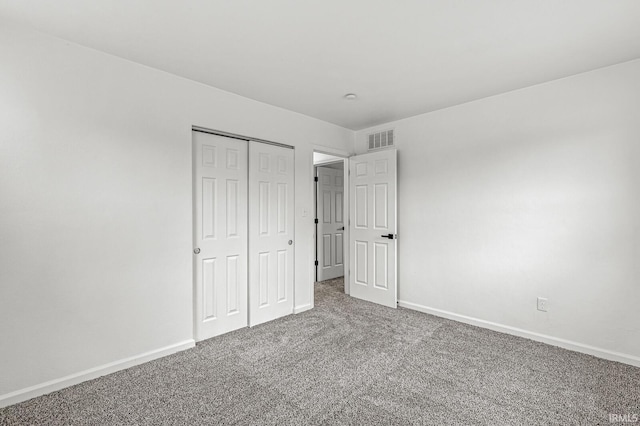 unfurnished bedroom with a closet and carpet