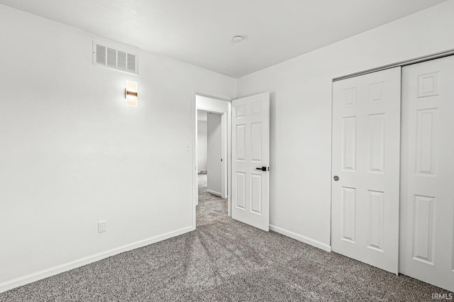 unfurnished bedroom featuring a closet and carpet