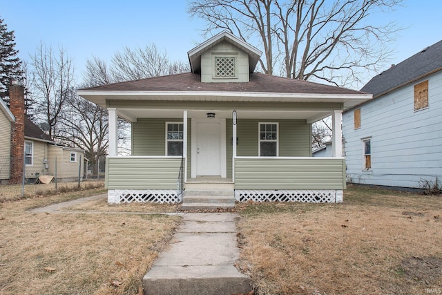 bungalow-style house featuring a porch and a front lawn