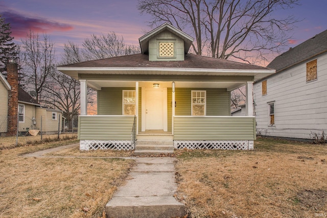 bungalow with a yard and covered porch