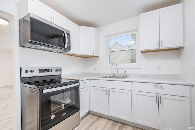 kitchen featuring white cabinetry, appliances with stainless steel finishes, and sink