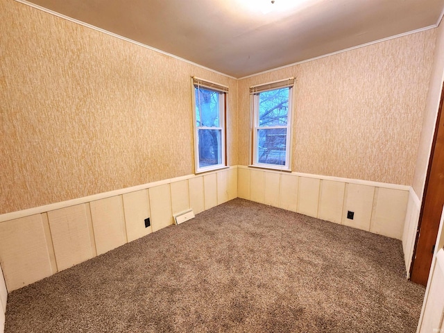 carpeted empty room featuring ornamental molding