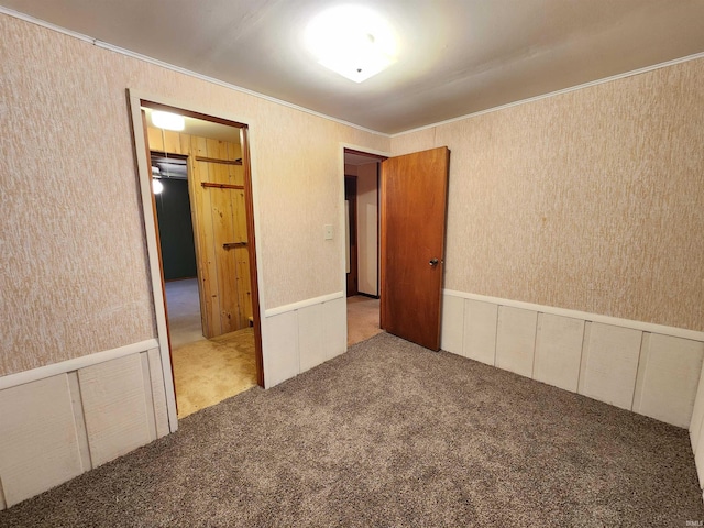 unfurnished bedroom with carpet floors and ornamental molding