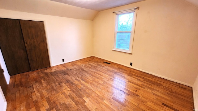 bonus room featuring vaulted ceiling and hardwood / wood-style floors