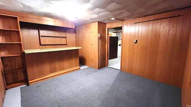 interior space featuring bar area and wooden walls