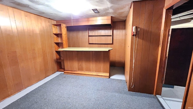 bar with light carpet and wood walls