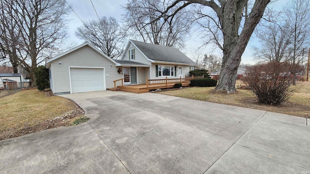 view of front of house with a garage, a front lawn, and a deck