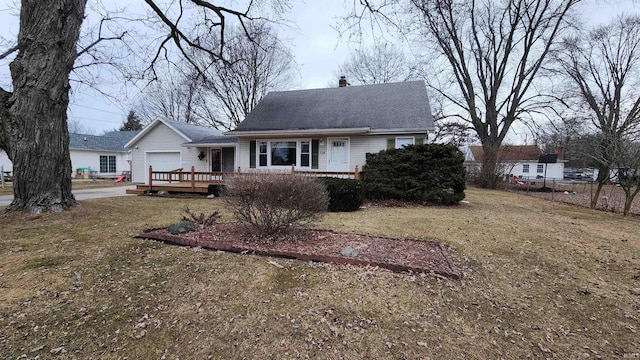 back of property with a yard and a garage