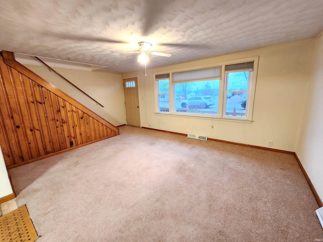 carpeted spare room with a textured ceiling