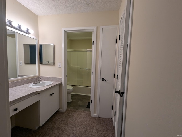 full bathroom featuring vanity, toilet, enclosed tub / shower combo, and a textured ceiling