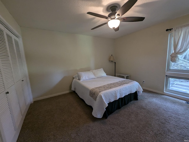 carpeted bedroom featuring ceiling fan and a closet