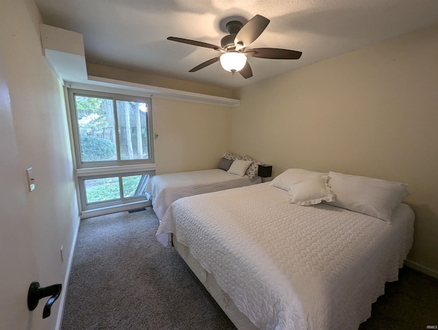 bedroom with ceiling fan and carpet flooring