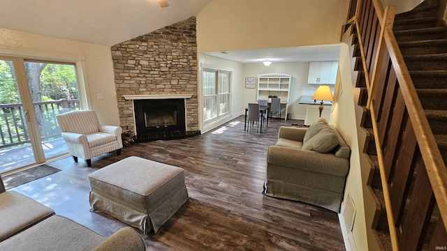 living room featuring a fireplace, dark hardwood / wood-style flooring, and high vaulted ceiling