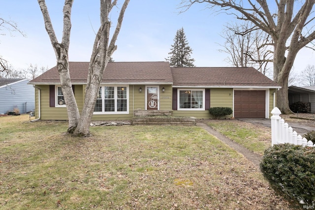 ranch-style home featuring a garage and a front lawn