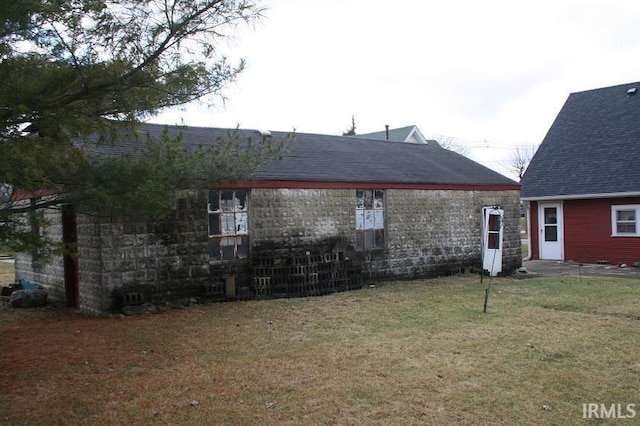 back of house with a lawn