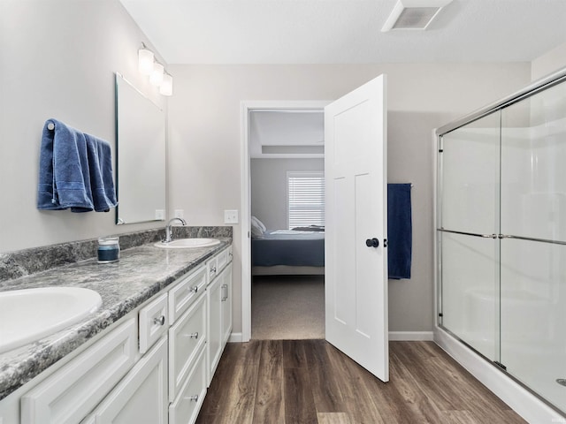 bathroom featuring vanity, hardwood / wood-style floors, and walk in shower